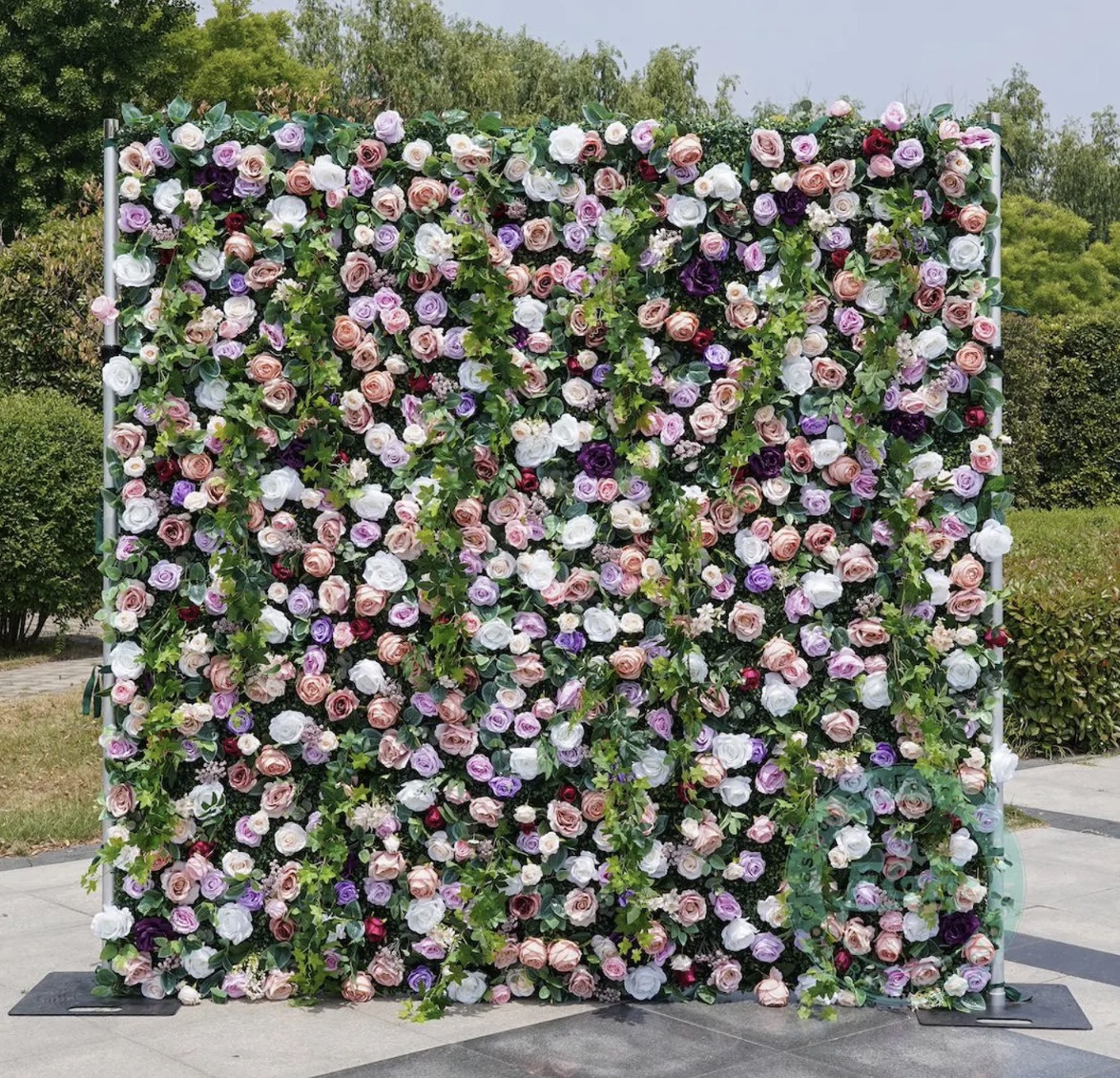 The Secret Garden pink, purple, white, and greenery flower wall